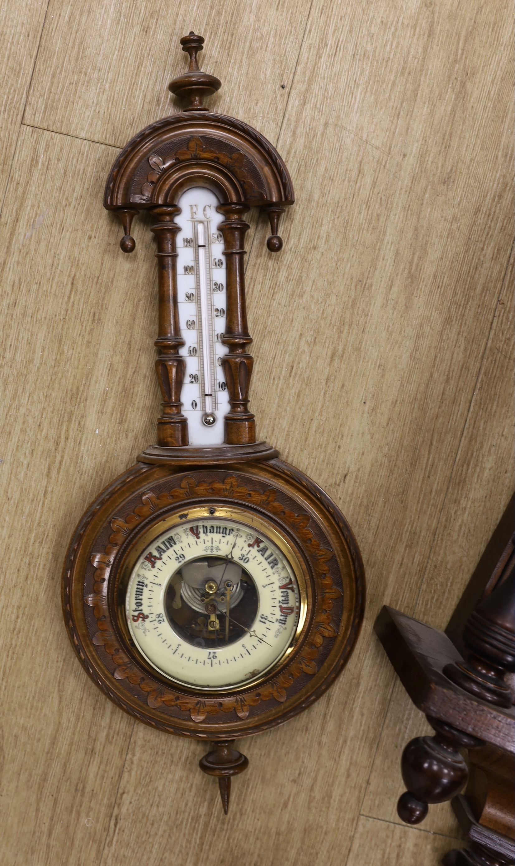 A mahogany Vienna wall clock and an aneroid barometer
